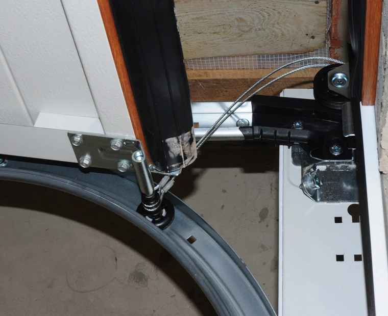 Technician working through a garage door cable repair