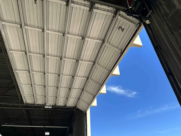 Large commercial overhead door opened inside an industrial building