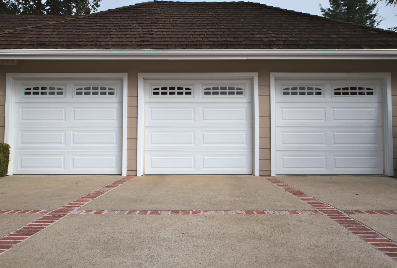 Garage door technician performing preventive maintenance and a tune-up