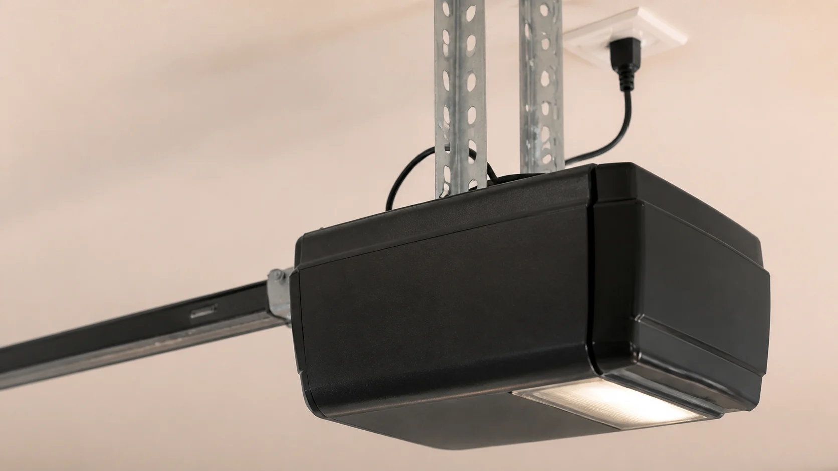 Close-up of a garage door opener motor housing and mounting brackets