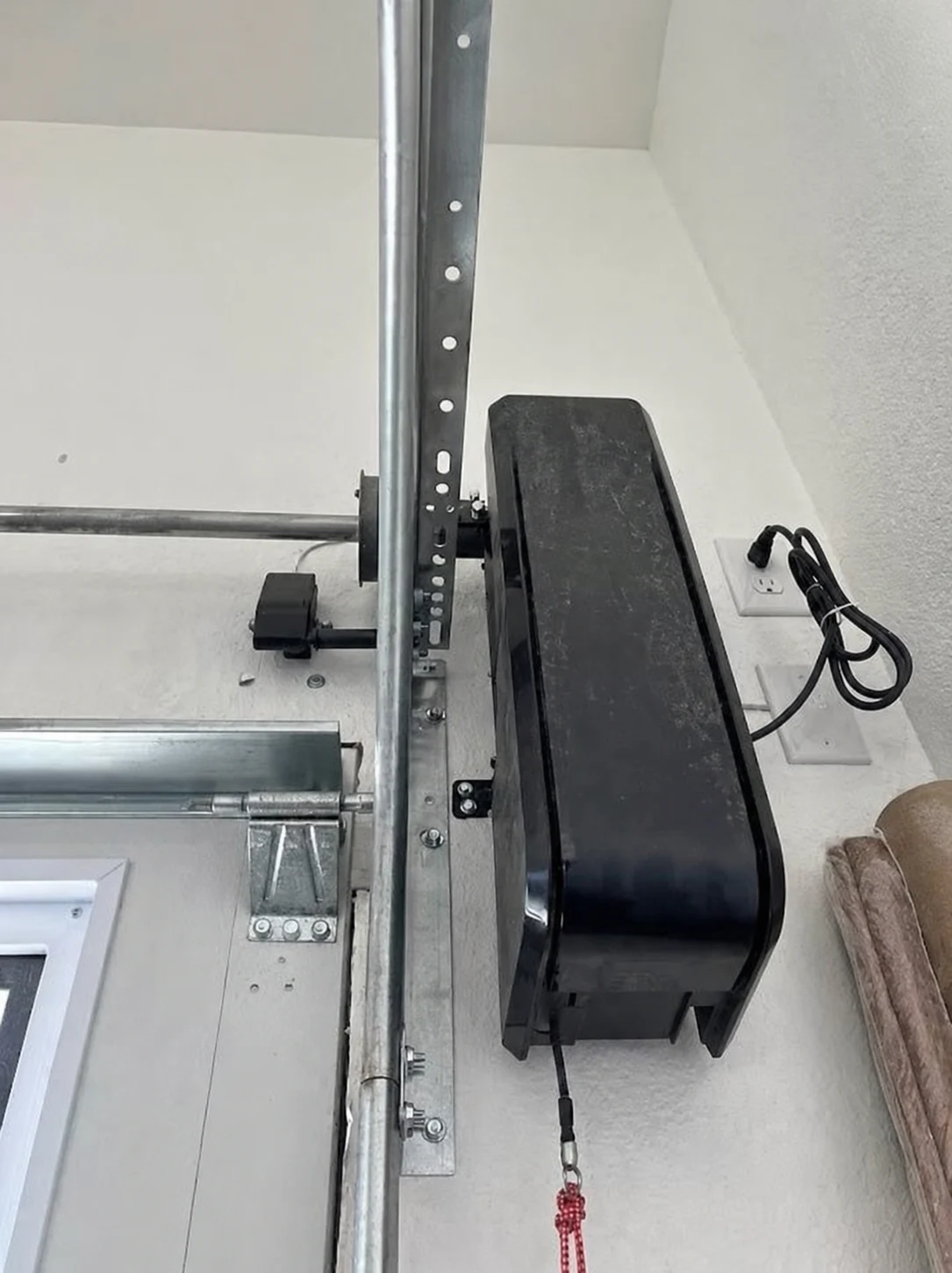 Close-up of a side-mounted opener connected beside a torsion shaft